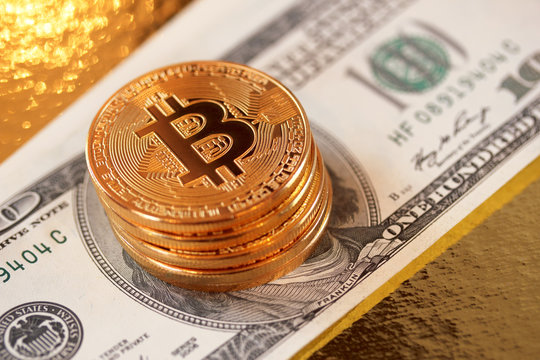 Golden bitcoin on a gold background