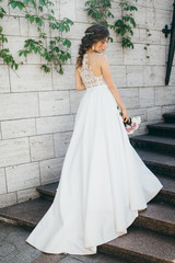 Stunning bride in the old garden at summer