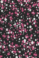Fond noir à pois rose et blanc.