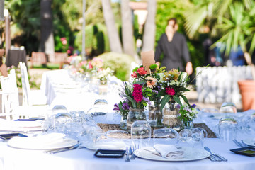 Close-up of tiny wedding bouquets on a restaurant table