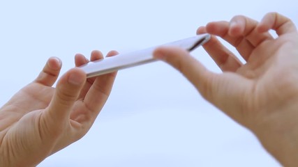 Male tourist taking video, moving smartphone up and down, viewing pictures - Powered by Adobe