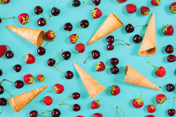Berries in waffle cones - strawberry and black cherry on blue ba