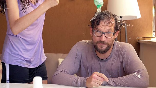 Woman doing prank on boyfriend splashing ice cold water on his head super slow motion 180fps closeup