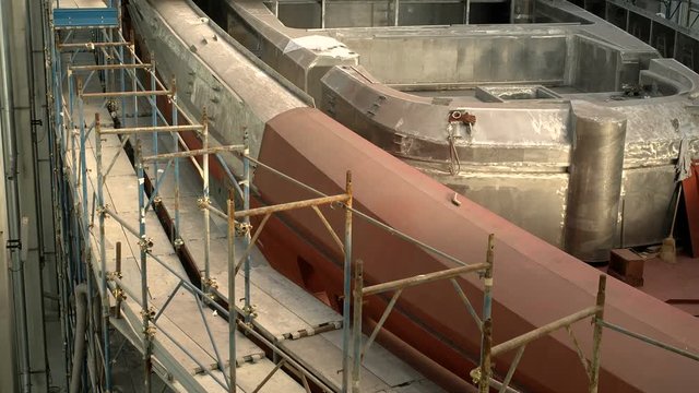 Main deck of a maxi yacht being built in a shipyard.