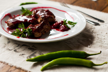 meat with fresh herbs and cherry sauce, ready to eat.