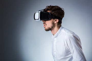 Side view of a young guy using a VR headset