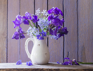 beautiful bouquet with irises on wooden table