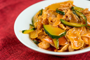 wok fried chicken stir fry with sweet peppers and chinese vegetables