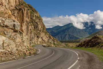 road mountains clouds curve asphalt