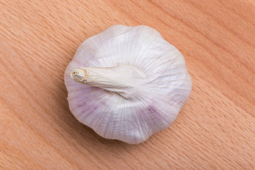Top view of white and fresh raw garlic bulbs place on wooden table, valuable herbal for healthiness.