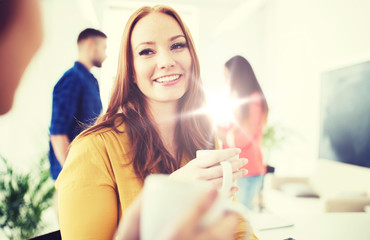 happy creative team drinking coffee at office