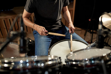 man playing drums at concert or music studio