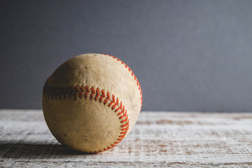 old Baseball and glove on wood background with filter effect retro vintage style