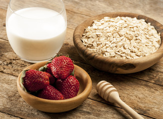 Healthy breakfast concept with oat flakes and fresh berries on rustic background. Food made of...