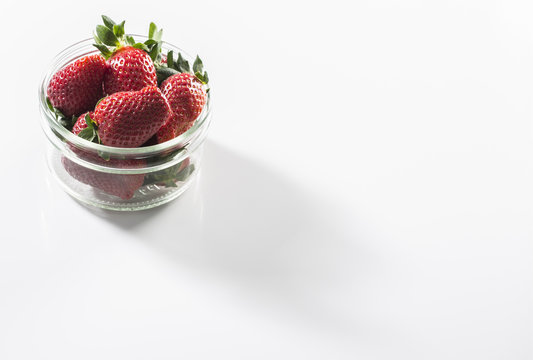 Juicy fresh strawberries in a white bowl