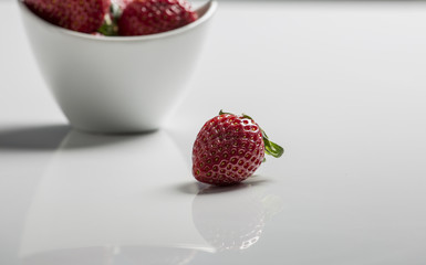 Juicy fresh strawberries in a white bowl