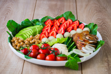 Warm grilled chicken salad with vegetables and fruits