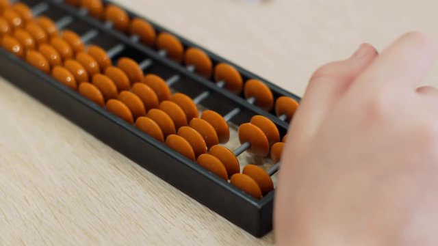Girl performs arithmetic tasks in Japanese close-up accounts