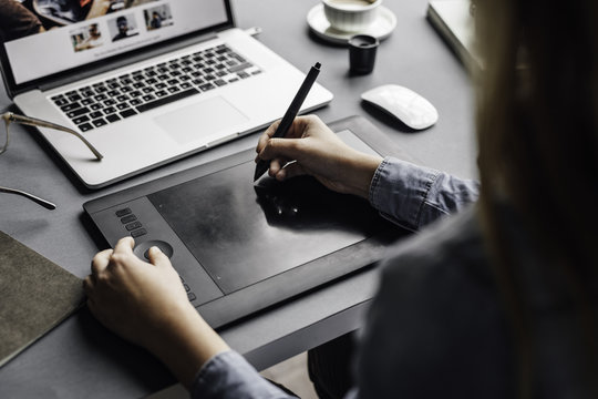 Graphic designer working on her computer at office