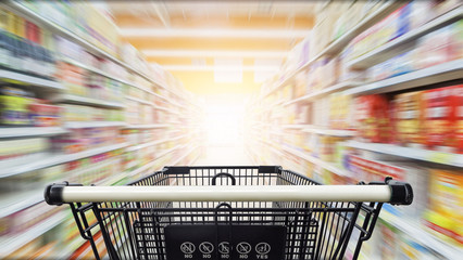 Supermarket aisle with empty black shopping cart