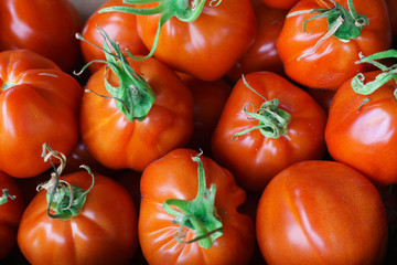 A box of red tomatoes sold on the market.