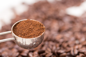 coffee measuring scoop over roasted beans