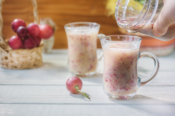 Grape smoothie over the white table.