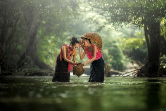 Two Lao girls are enjoying swimming in Asian rivers.