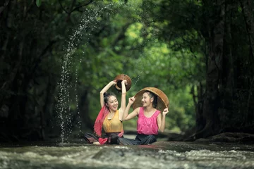 Fotobehang Two Lao girls are enjoying swimming in Asian rivers. © Oulailux