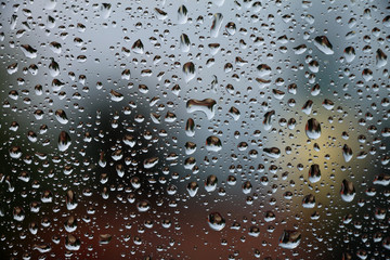 Raindrops on window glass , rainy day