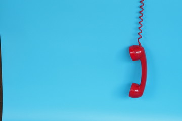 Red vintage telephone over blue background color 
