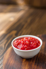 Indian chutney or mexican salsa in white ceramic bowl.