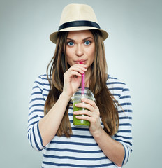 Beautiful woman drinking green smoothie juice.