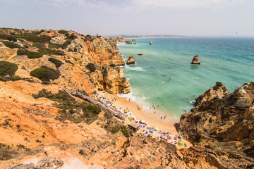 Fototapeta na wymiar Beautiful atlantic ocean view horizon with sandy beach rocks with stairs on beach on Atlantic ocean in Portugal