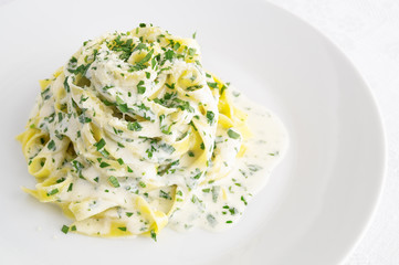 fettuccine pasta with alfredo sauce, cream, and parsley