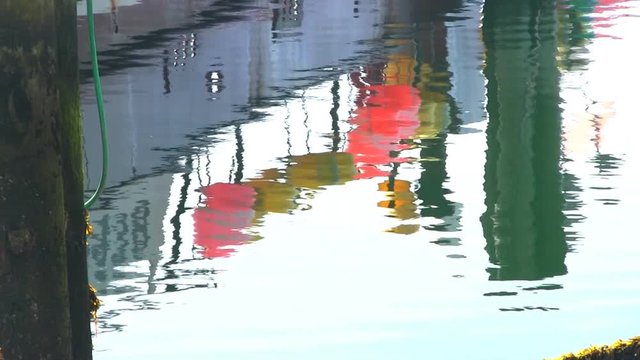 Fishing marker buoy boat reflection at harbor marina on cape cod