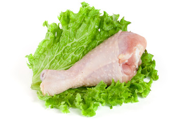 raw chicken drumstick with lettuce leaf isolated on white background