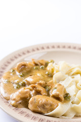 Flat lay chicken breasts with sauce and pasta.