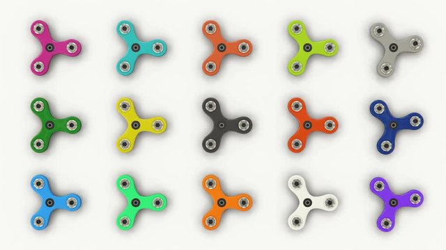 Colored fidget spinners spinning on white background, viral toy, stress reliever. Loopable fidget spinner background

