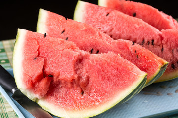 Slices of watermelons on the table with black background.