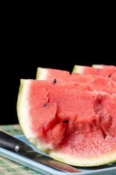 Slices of watermelons on the table with black background.