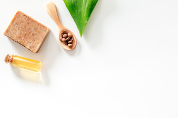Homemade skin care. Coffee soap on white background top view copyspace