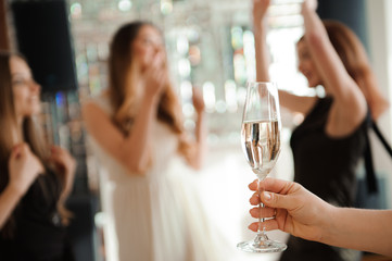 Group people with champagne dancing at the party.