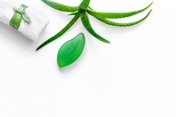 Natural herbal skin care. Aloe vera leafs and soap on white background top view copyspace