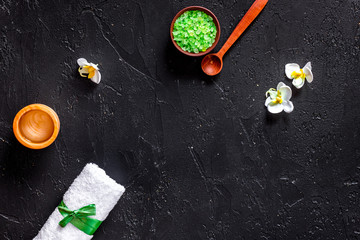 Organic skin care. Gel and spa salt on black table background top view copyspace