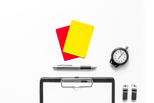 Set to judge competition. Yellow and red cards, stopwatch, whistle, pad on white background top view
