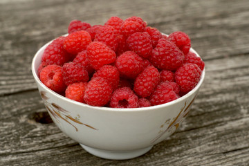 fresh sweet raspberry plate on wooden table 