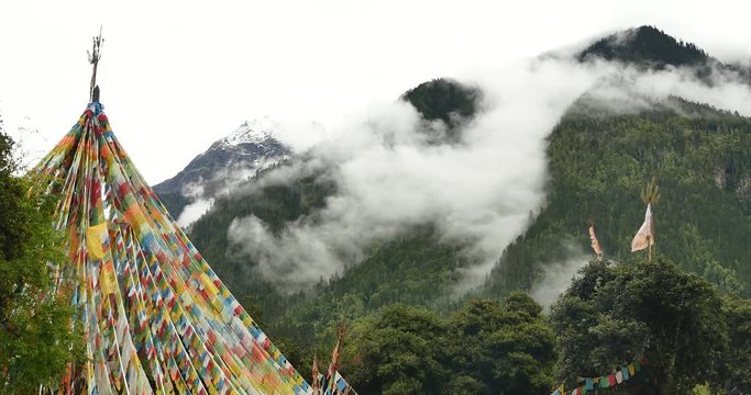 4k prayer flag with snow mountain in tibet.