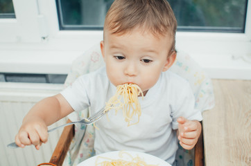 the child greedily eating pasta
