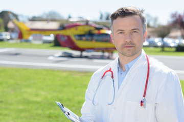 Portrait of doctor, air ambulance in background © auremar